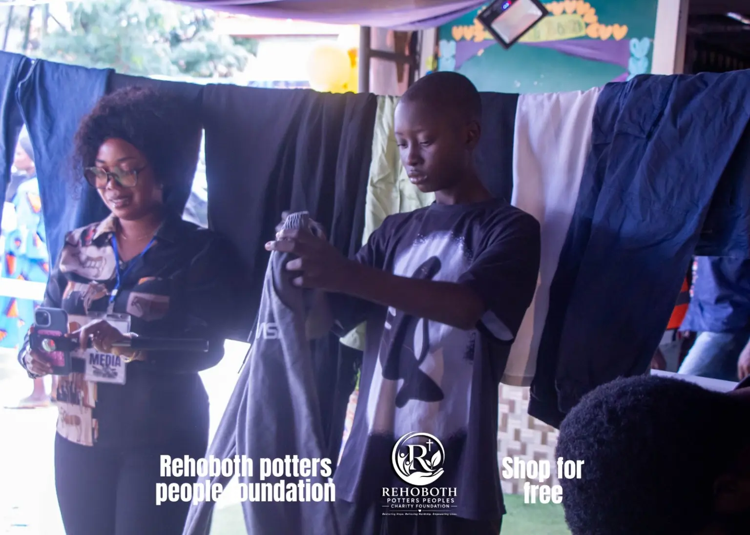 A participant choosing an item from a clothing rack