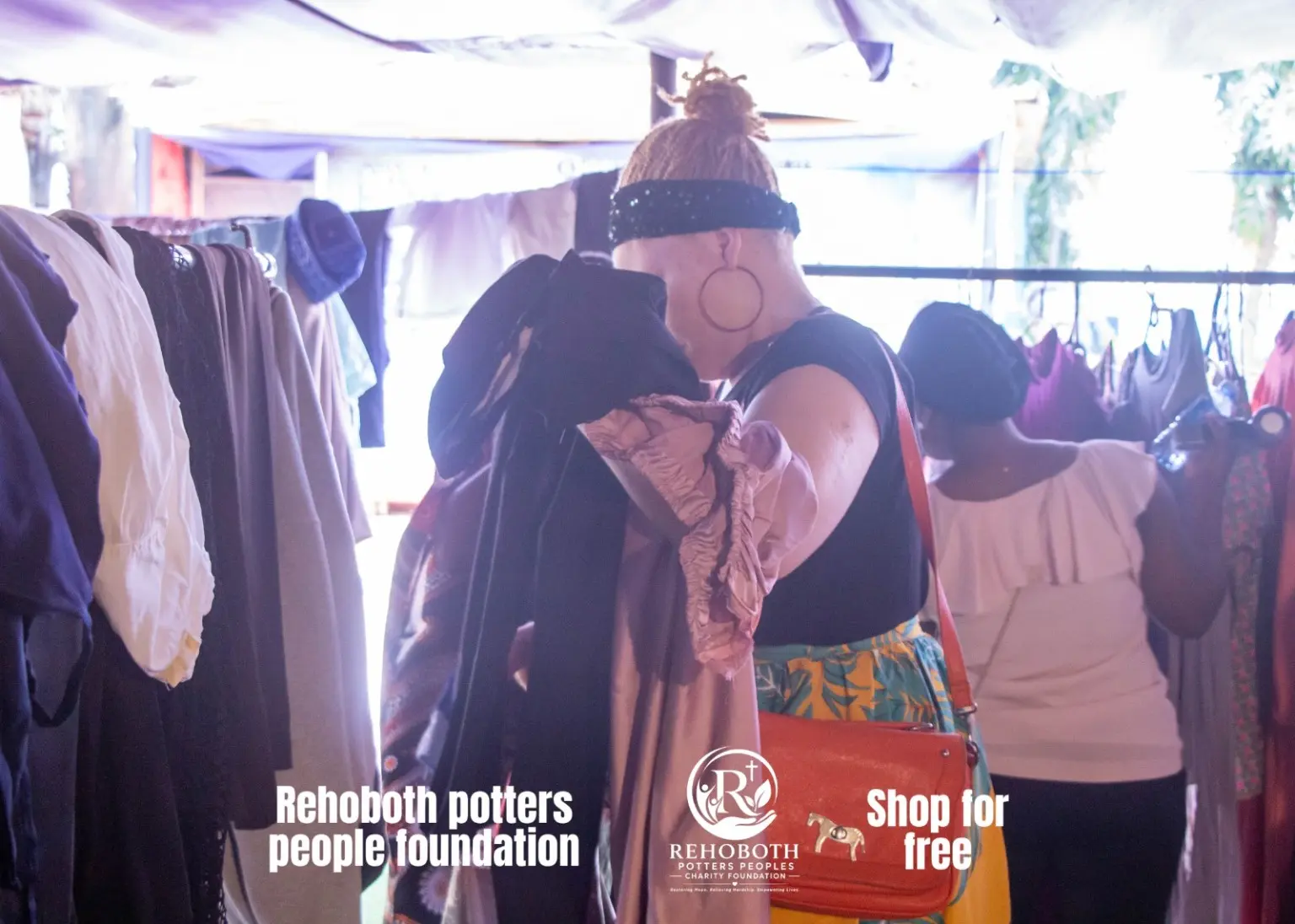 Volunteer helping a participant select clothing